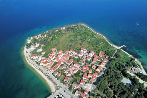 an island in the ocean with houses on it at Sunset Apartment in Zadar