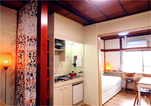 a room with a kitchen and a bed and a table at Kiki HouseT --Self Check-in -- Room Number & Password is in the following email in Tokyo