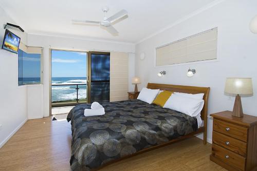 a bedroom with a bed with a view of the ocean at Lennox on the Beach Unit 2 - Lennox Head in Lennox Head