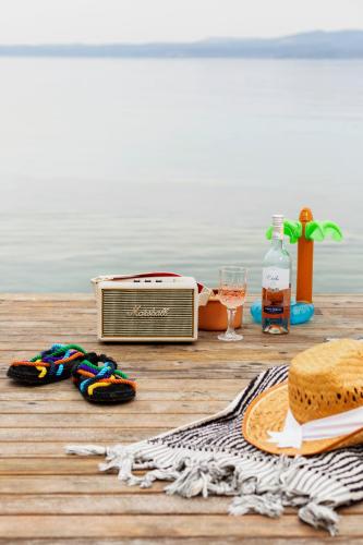 a table with a radio and a hat and a towel at Şato Design Hotel in Cesme