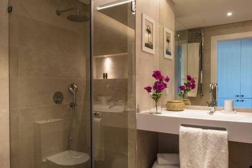 a bathroom with a shower and a sink and a toilet at Herdade Do Sobroso Wine & Luxury Boutique Hotel in Pedrógão