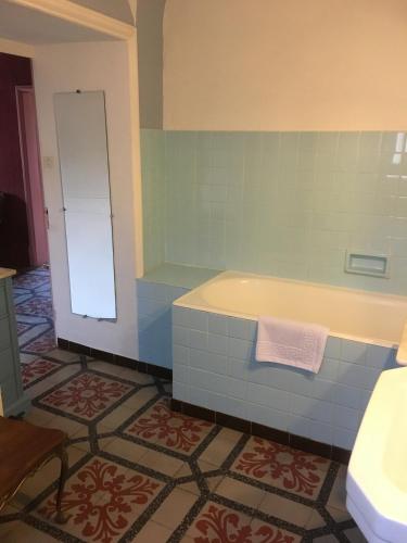 a bathroom with a tub and a sink at Manoir de Champvert in Les Vans
