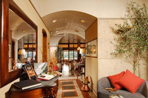a living room filled with furniture and a large window at Hotel Cacciani in Frascati