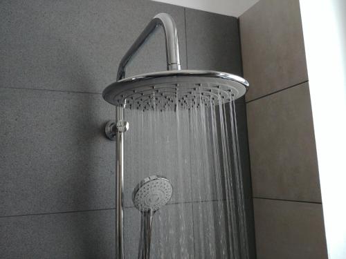 a shower with a shower head in a bathroom at Memory Apartments in Ayia Napa