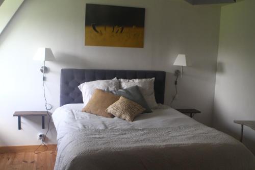 a bed with two pillows on it in a bedroom at Le lit de la Saâne in Auzouville-sur-Saâne