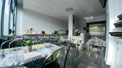 a dining room with a table and chairs at H&ocirc;tel du Tramway in Laon