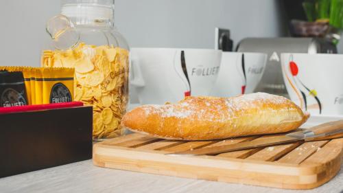 a loaf of bread sitting on a cutting board at Hôtel du Tramway in Laon