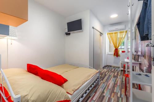 a hospital room with a bed and a tv at Center Rooms with terrace in Rijeka