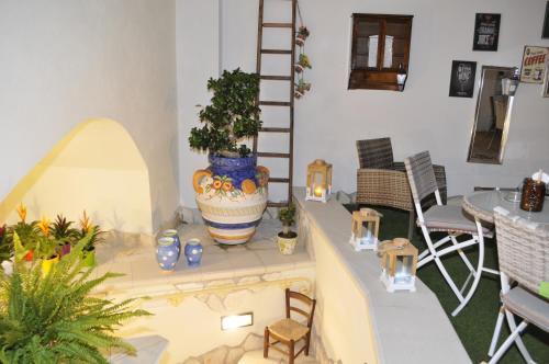 a room with a table with a large vase on it at V&V Suite & Breakfast in Pompei