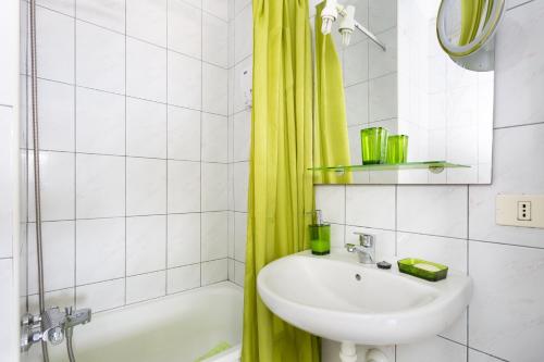 łazienka z umywalką i żółtą zasłoną prysznicową w obiekcie Apartamento vistas al mar Valle Luz w Puerto de la Cruz