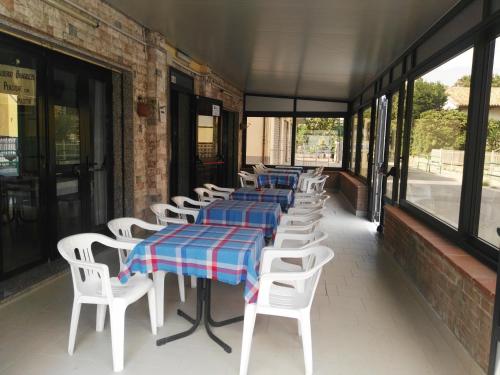 a row of tables and chairs on a building at Hotel Bragozzo in Sottomarina