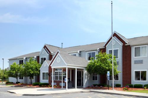 a rendering of the front of a building at Americas Best Value Inn - East Syracuse in East Syracuse