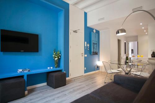 a living room with a blue wall at Habitat Apartments ADN in Barcelona