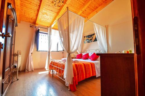 a bedroom with a bed with red pillows at La Vecchia Torre in Giarre