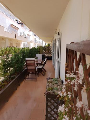 a patio with a table and chairs on a balcony at Caia Formosa T1 in Cabanas de Tavira