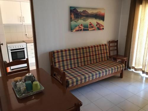 a living room with a couch and a table at Edificio Caique C in Armação de Pêra