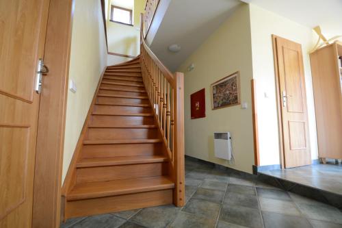 a wooden staircase in a room with a door at Penzion Art kutna Hora in Kutná Hora
