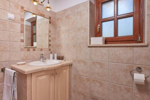 a bathroom with a sink and a mirror at Villa Sujevic in Motovun