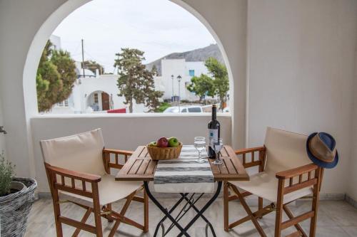 a table and chairs on a balcony with a window at Cultural House in Pyrgos