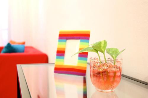 a colorful vase with a plant in it on a table at Vista Horizon Melaka in Melaka