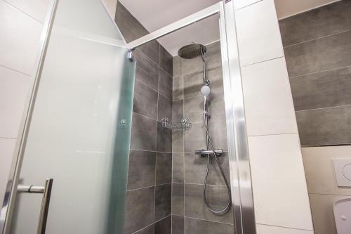 W łazience znajduje się prysznic ze szklanymi drzwiami. w obiekcie HOTEL 63 w Popradzie