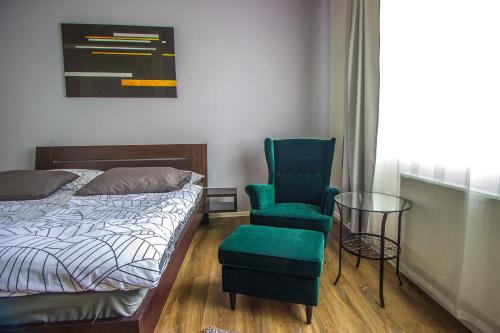 a bedroom with a bed and a chair and a glass table at HOTEL 63 in Poprad