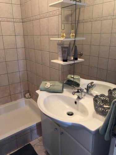 a bathroom with a sink and a bath tub at Apartment Danijela No. 2 in Novalja