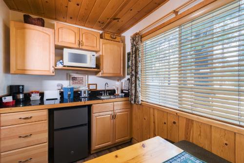 a kitchen with wooden cabinets and a microwave at Fireside Lodge in South Lake Tahoe