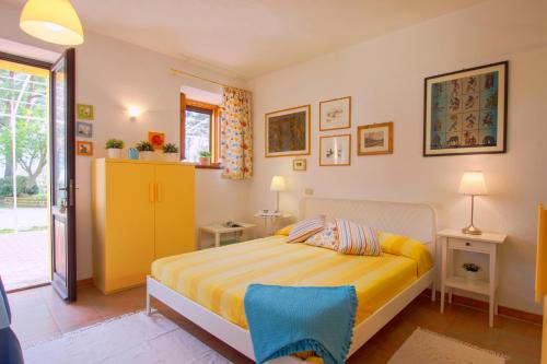 a bedroom with a yellow bed and a yellow door at Il Casale Di Montefreddo in Sirolo