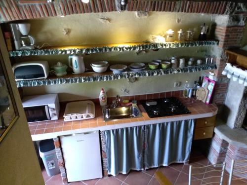 a small kitchen with a stove and a sink at Antonia & Arian in Roč