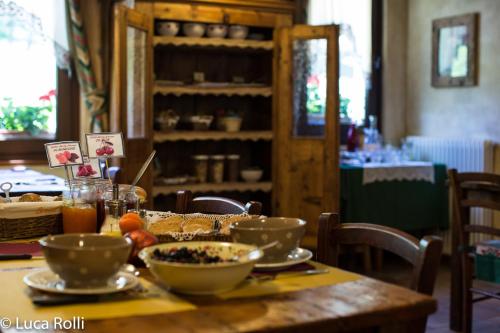 a wooden table with bowls of food on it at Hotel Della Nouva in Pila