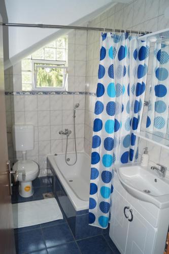 a bathroom with a tub and a toilet and a sink at Apartment Drago in Rakovica