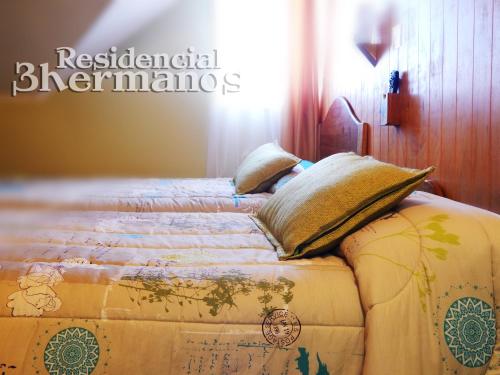 En eller flere senge i et værelse på Residencial Tres Hermanos