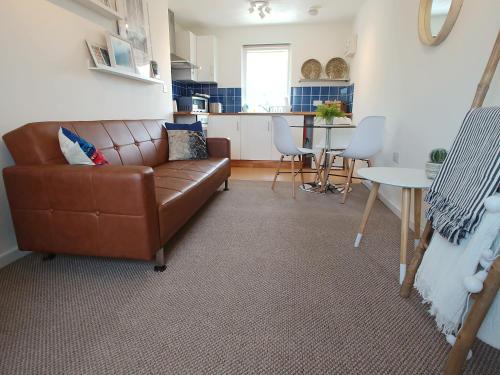 una sala de estar con un sofá y una mesa en The Oldbrook Apartment, en Milton Keynes