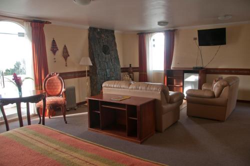 a living room with a couch and a table at Taypikala Lago in Puno