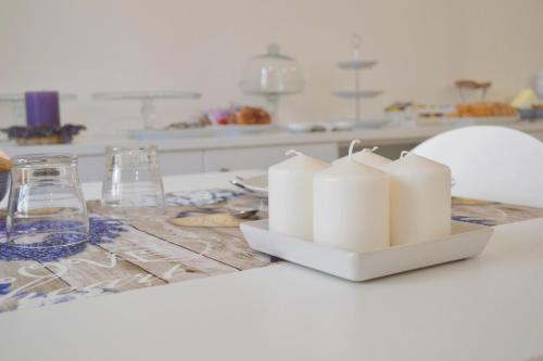 a kitchen counter with a white counter top with candles at B&B Santa Lucia, Rapolla in Rapolla
