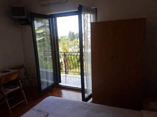 a bedroom with a door open to a balcony at Apartments Zova in Medulin