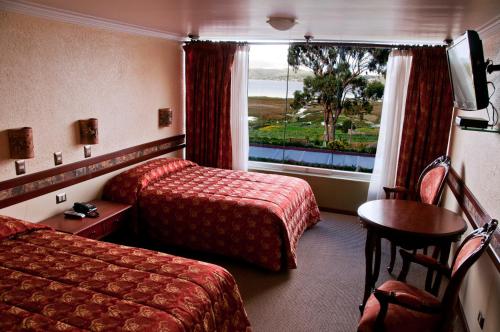 a hotel room with two beds and a window at Taypikala Lago in Puno