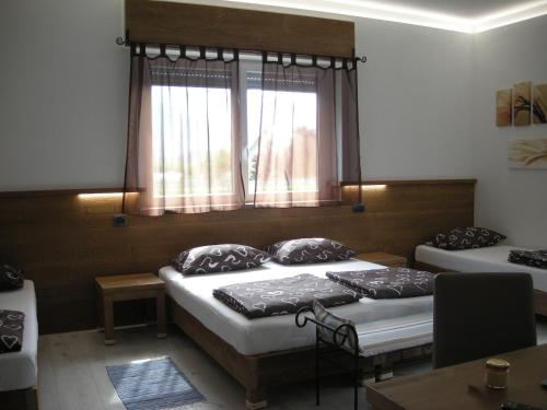 a room with two beds and a window at B&B Il Crocevia in Teglio