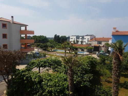 a view of a city with palm trees and buildings at Apartments Zova in Medulin