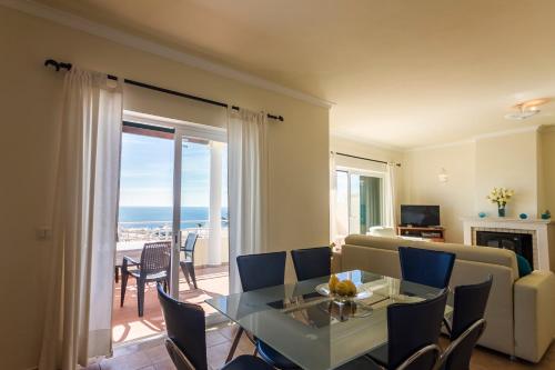 a living room with a couch and a table with chairs at Villa Acacias 13 in Luz