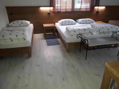 a group of four beds in a room at B&B Il Crocevia in Teglio