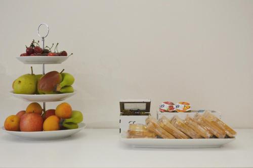 two plates of fruit and pastries on a table at B&B Santa Lucia, Rapolla in Rapolla