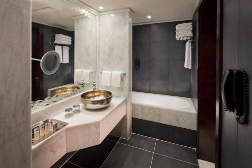 a bathroom with a tub and a sink and a bath tub at Jumeirah Zabeel Saray Dubai in Dubai