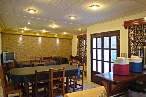 a dining room with a table and some chairs at Esquina Apart in Esquina
