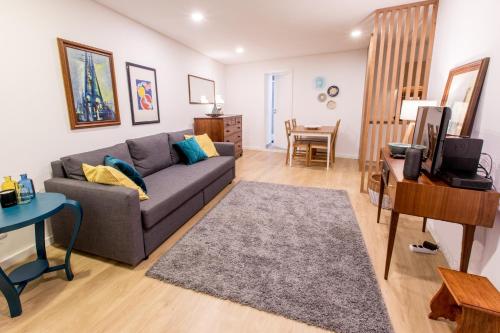 a living room with a couch and a table at Casa do Tanque in Arouca