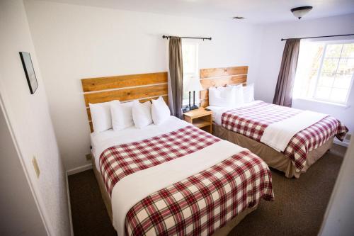 a hotel room with two beds and a window at View Crest Lodge in Trinidad