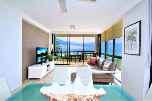 a living room with a view of the ocean at Capricorn One Beachside Holiday Apartments - Official in Gold Coast