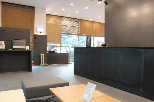 an office lobby with a desk and a table and a counter at Hyundai Residence in Seoul