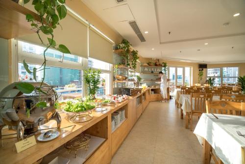 a restaurant with a counter with food on it at Nhat Minh Hotel and Apartment in Da Nang